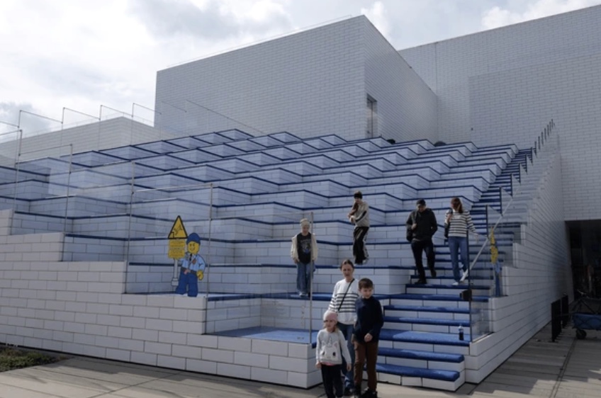 Stacked modular brick facade of the LEGO House — a metaphor for MACH architecture