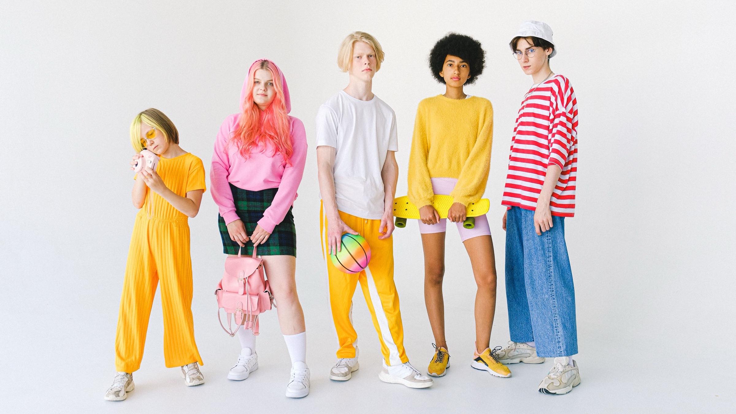 Group of young people in colorful pastel fashion on a light background — direct-to-consumer fashion D2C platform in Mexico